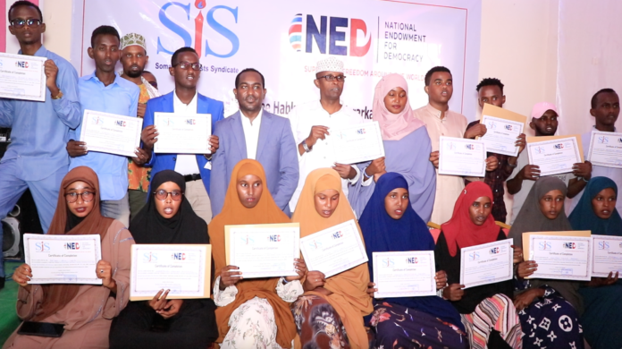 Participants pose for a group photo following the conclusion of a three-day human rights journalism training in Galmudug, Somalia on Saturday 11 June 2022. | PHOTO/SJS.